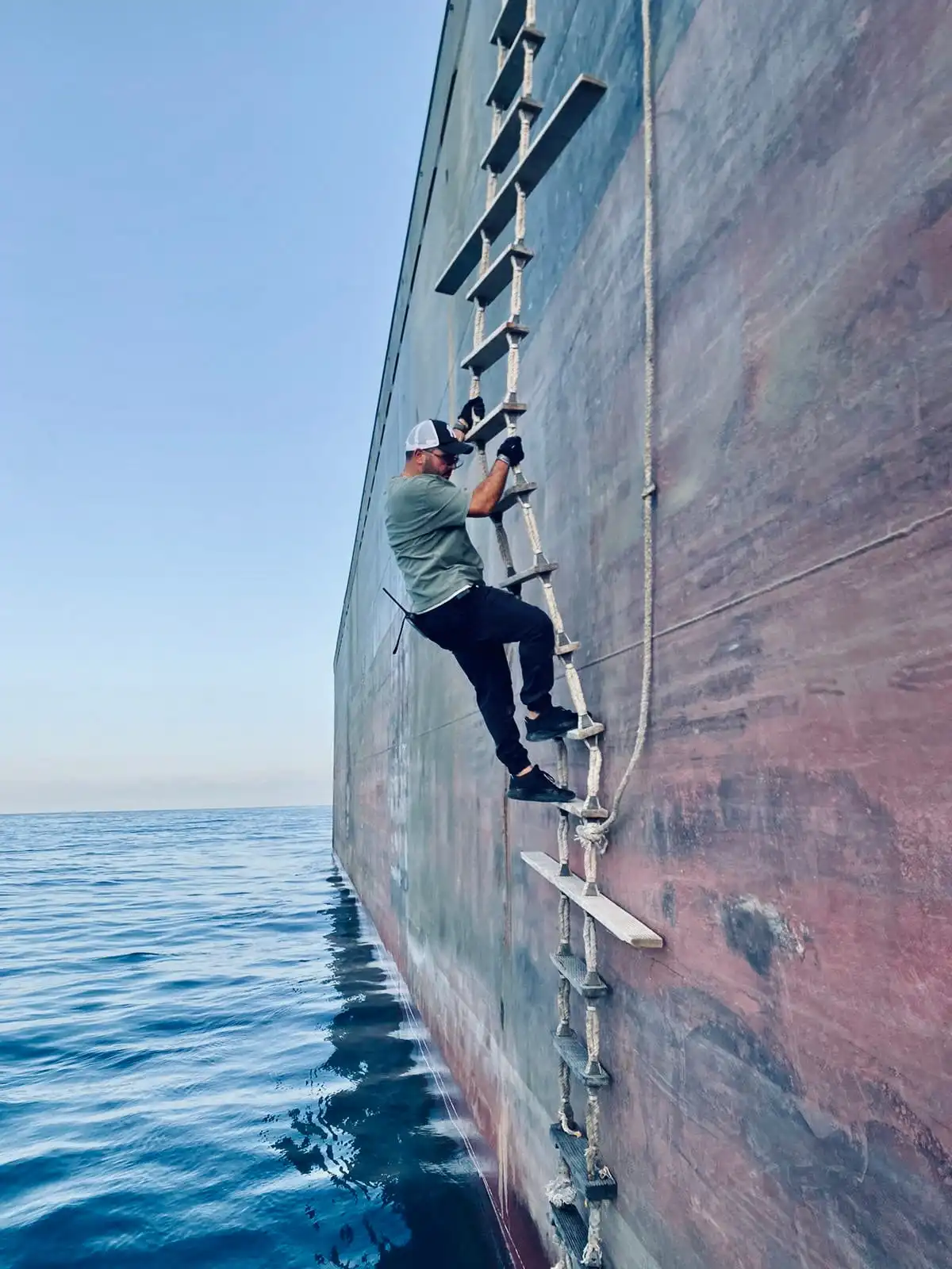 Alexandre Kfoury climbing a pilot ladder aboard one of his vessels